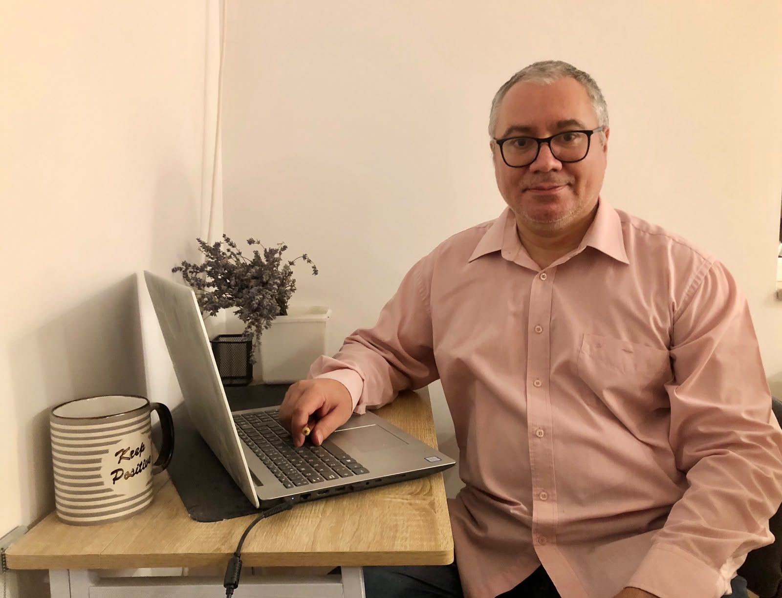 Virgil Ionut Deaconu, Romanian teacher, at his desk with a laptop